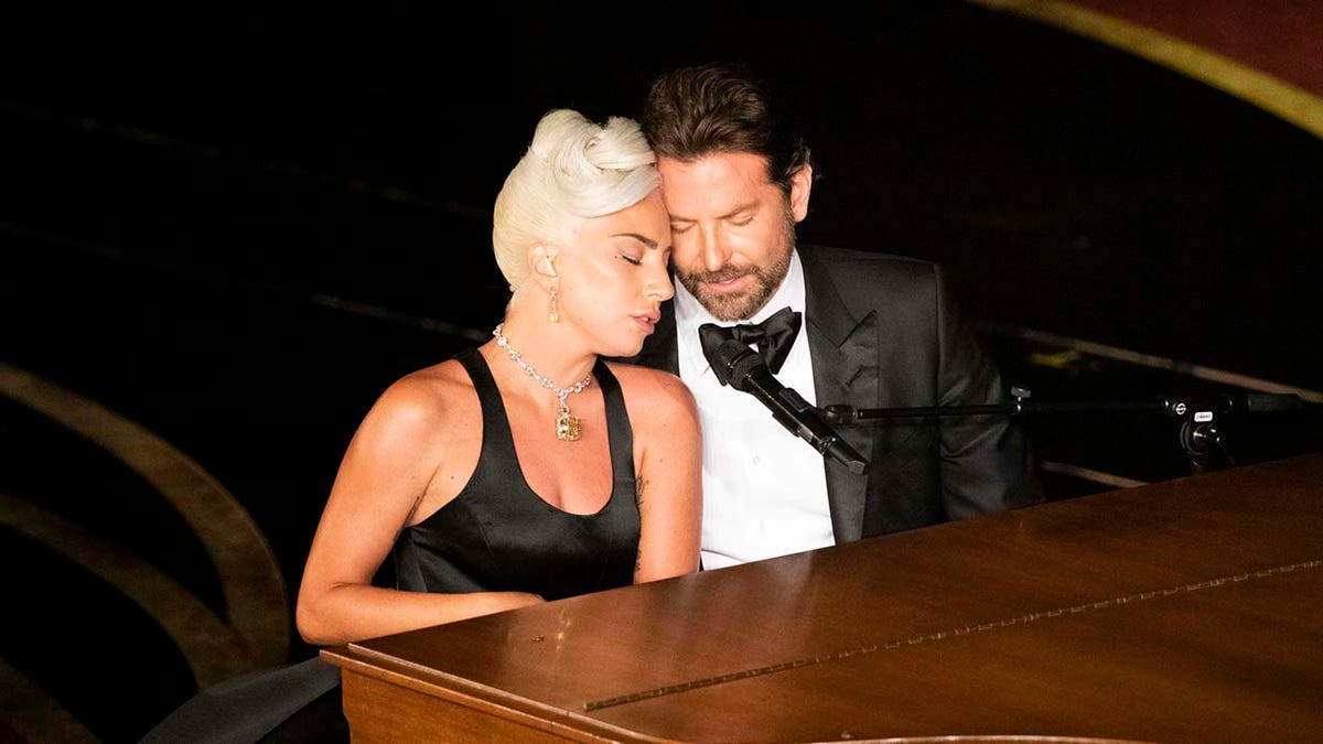 Bradley Cooper playing the piano with Lady Gaga