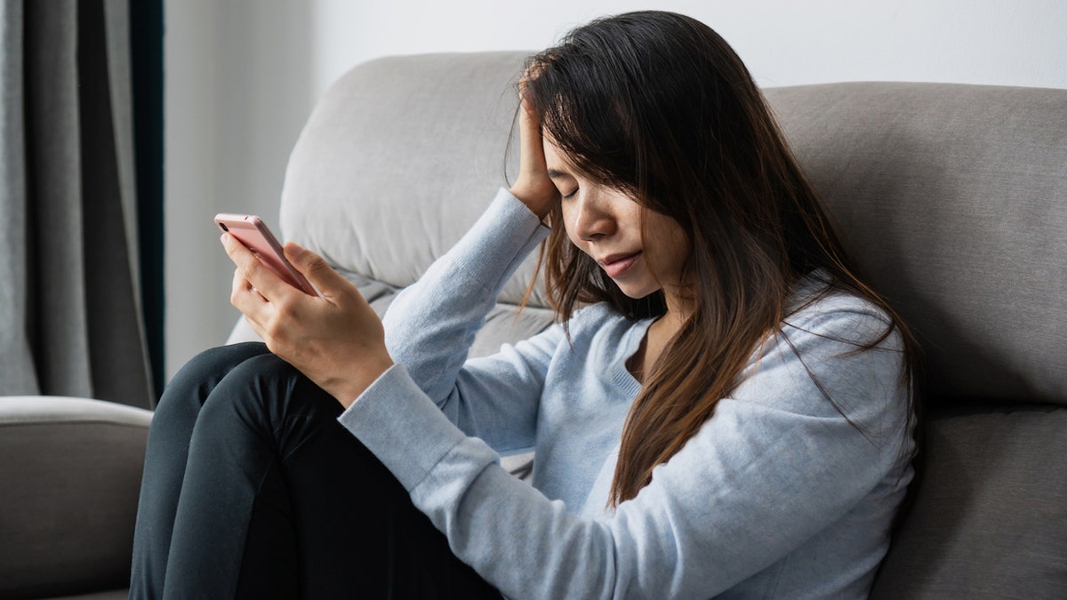 Depressed woman with phone