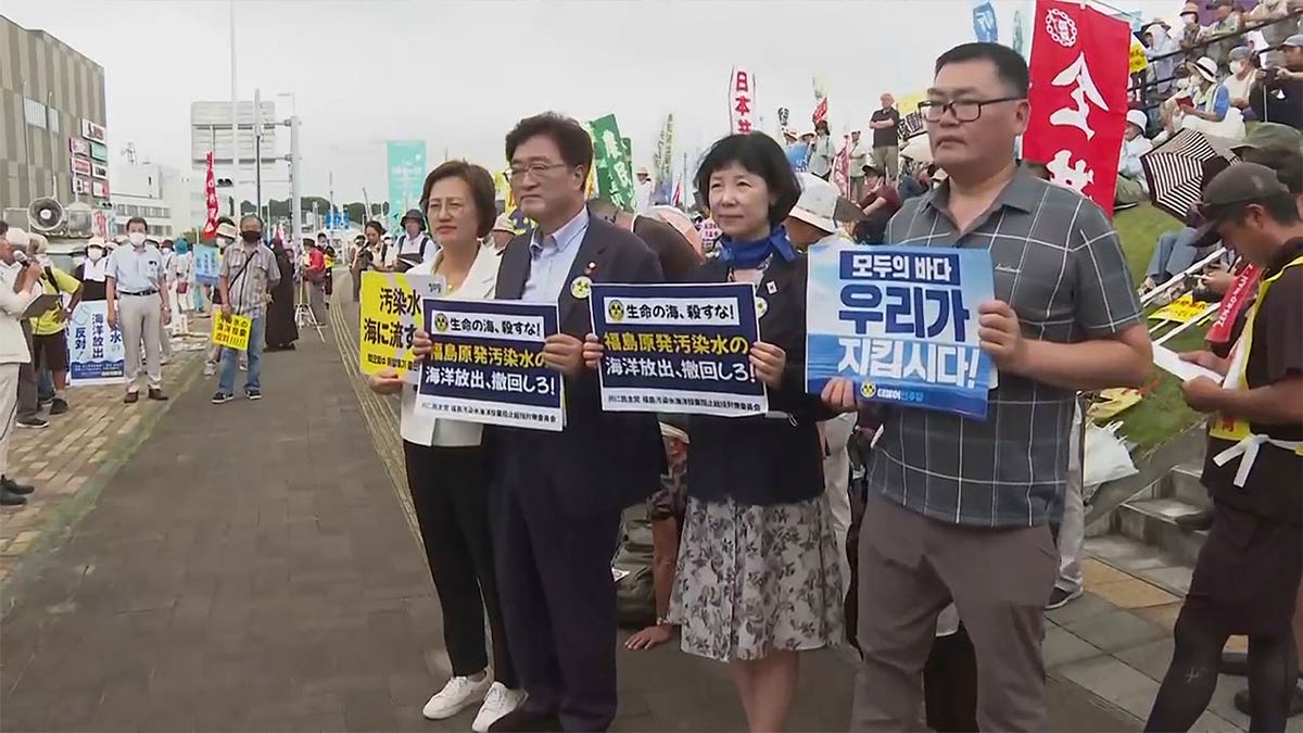 protestors hold cards