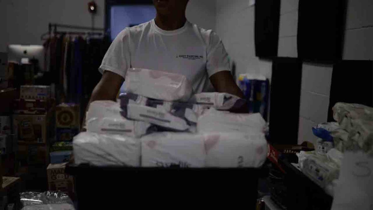 man holding box of diapers