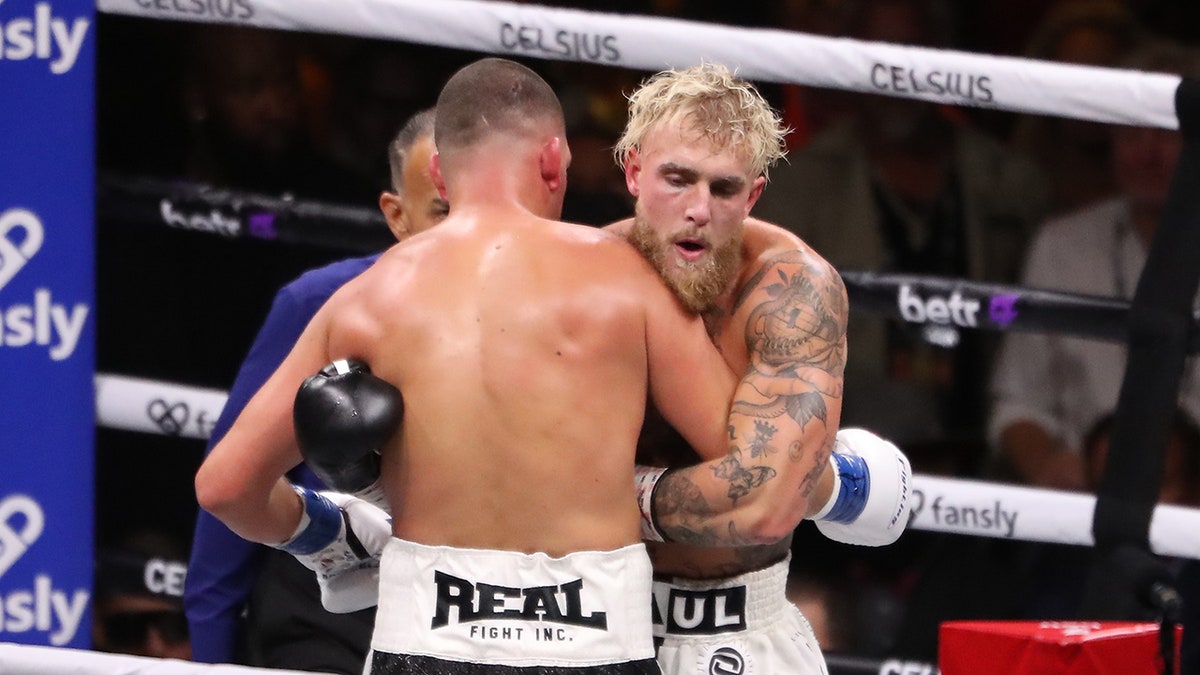 Jake Paul hugs Nate Diaz