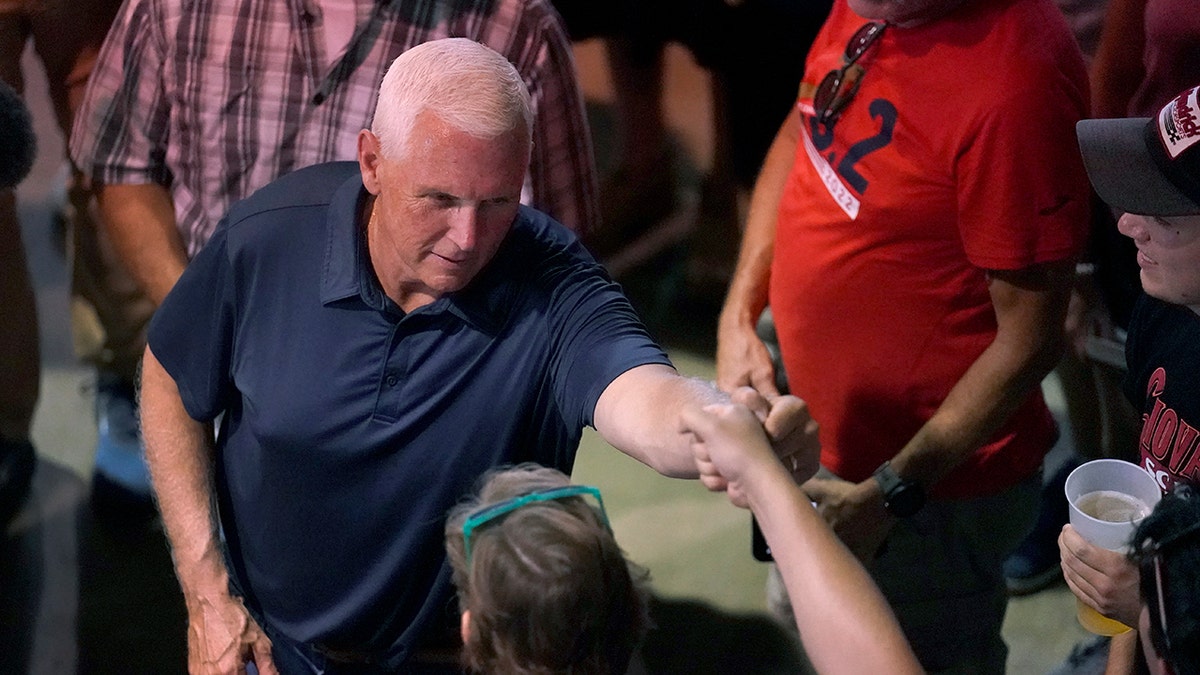 Republican presidential candidate Mike Pence shakes a voter's hand in Iowa