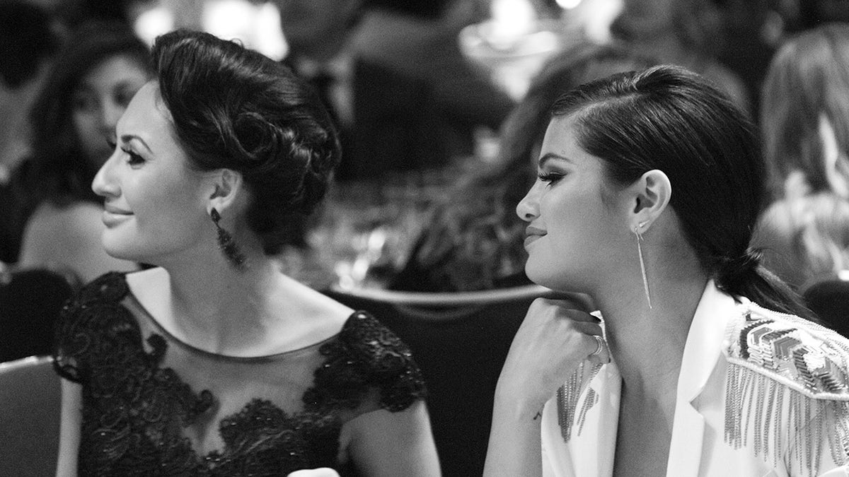 Francia Raisa and Selena Gomez sitting together
