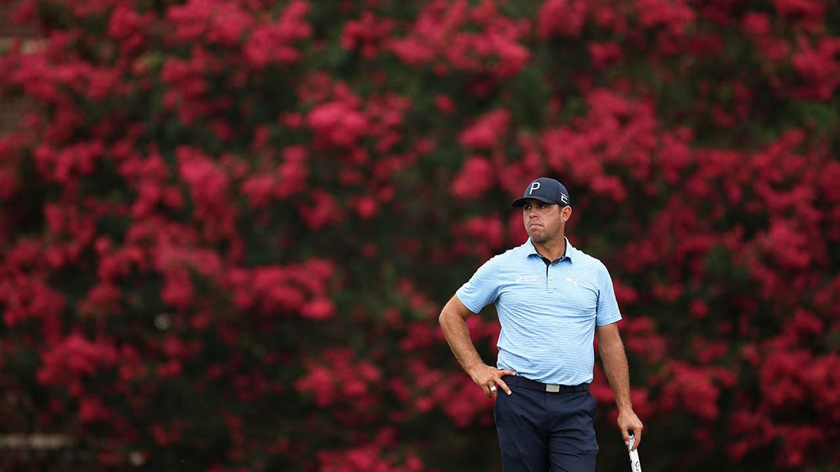 Gary Woodland stands on the green