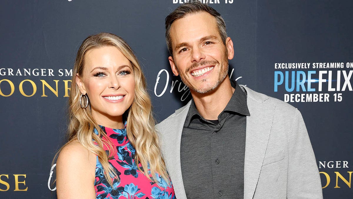 granger smith with wife amber on red carpet