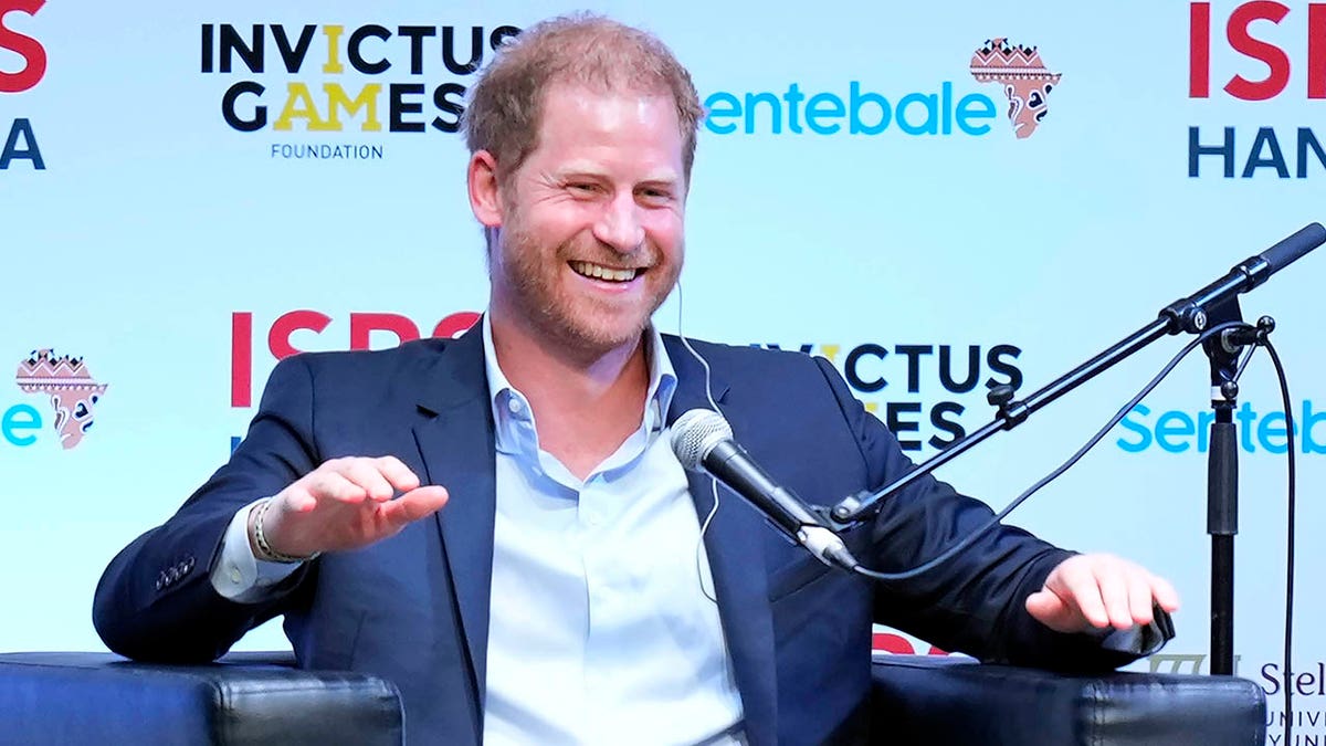 prince harry sitting on panel at sports summit in japan