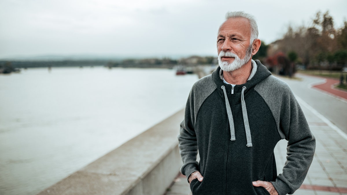 man on a walk near water