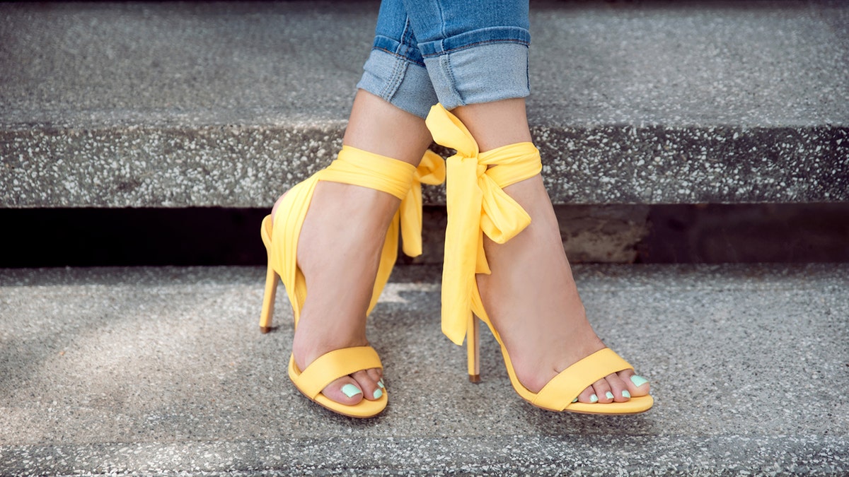 woman wears yellow sandals