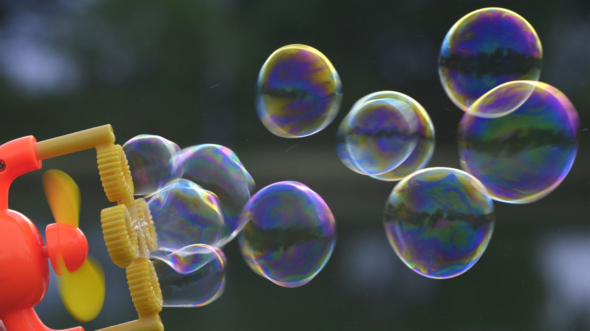 A bubble gun in-use outside.