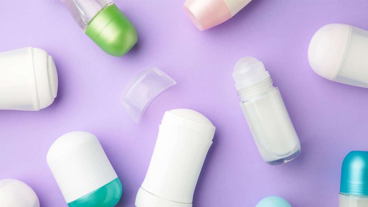 Antiperspirants and deodorants set on a purple background.