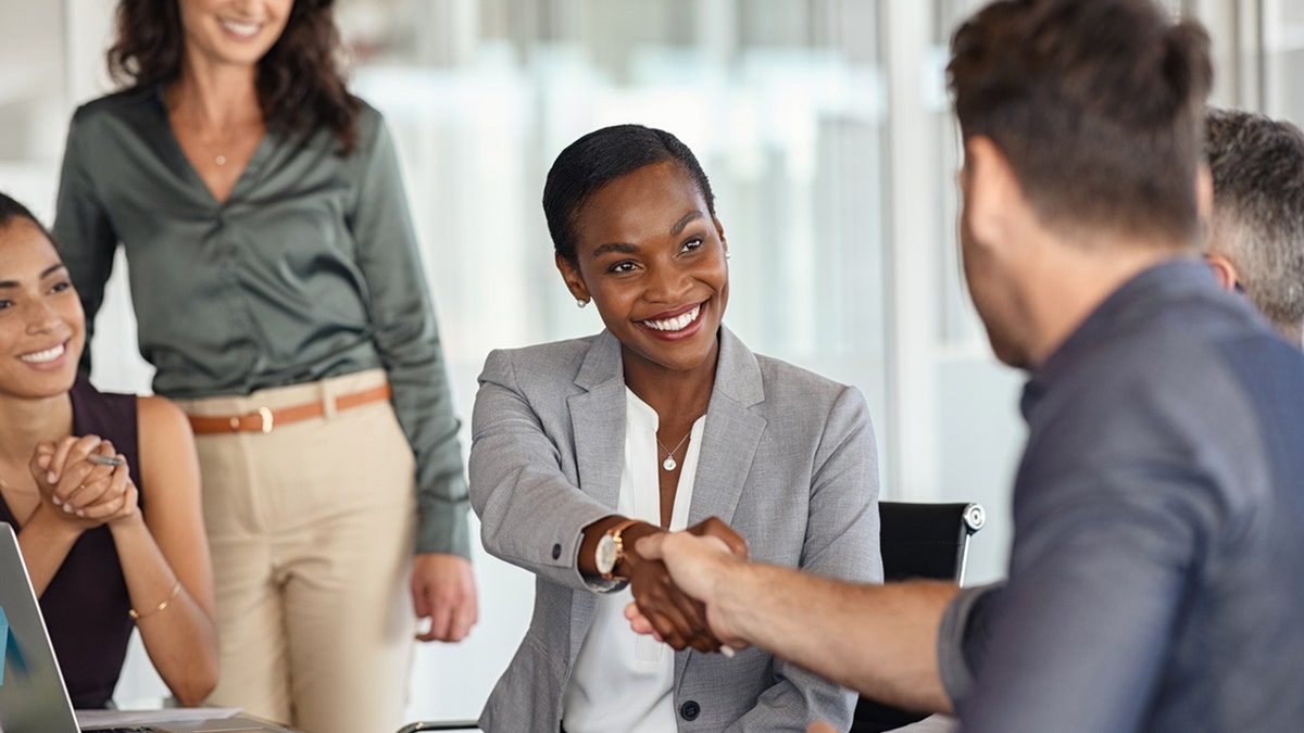 coworkers shake hands