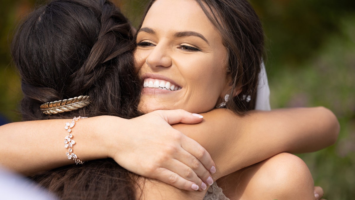 Bride hugs wedding guest.