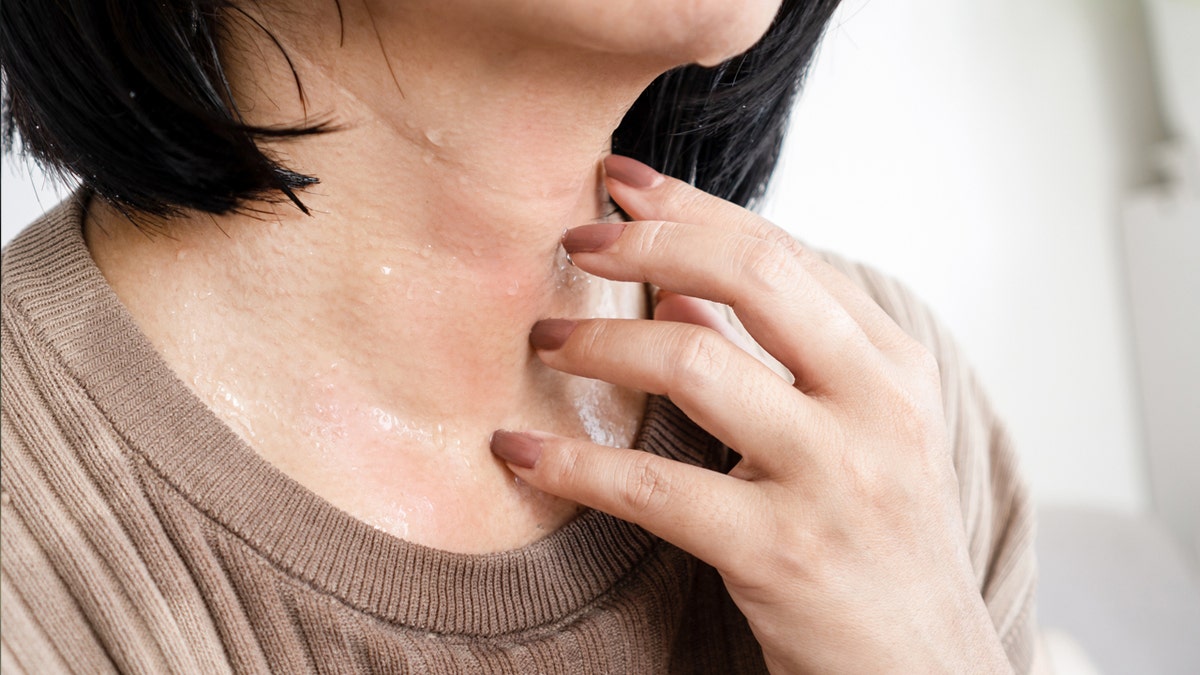 Close up of woman's sweaty neck.
