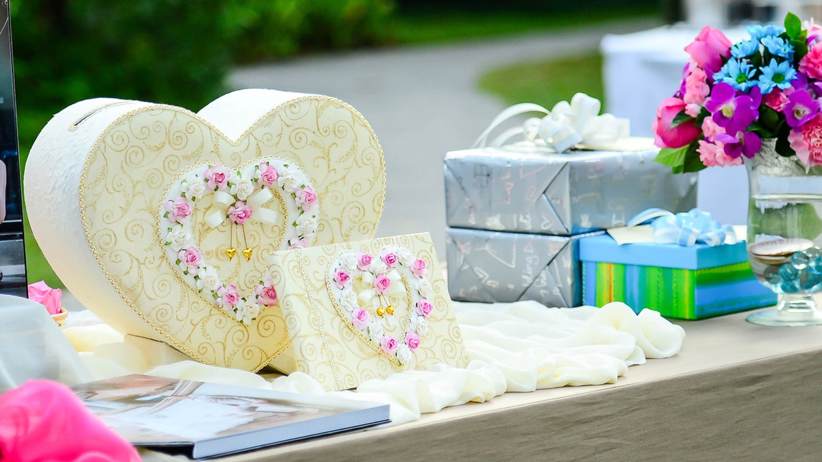 Wedding gifts arranged on gift table.