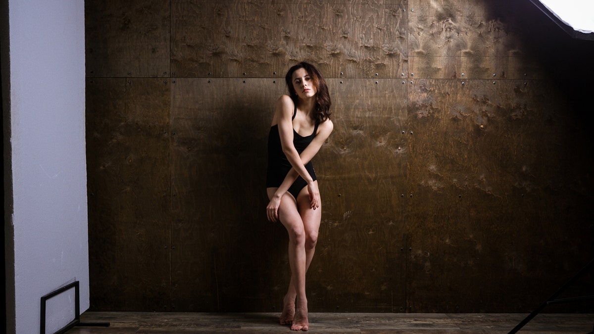 Woman models underwear on a photo shoot set.