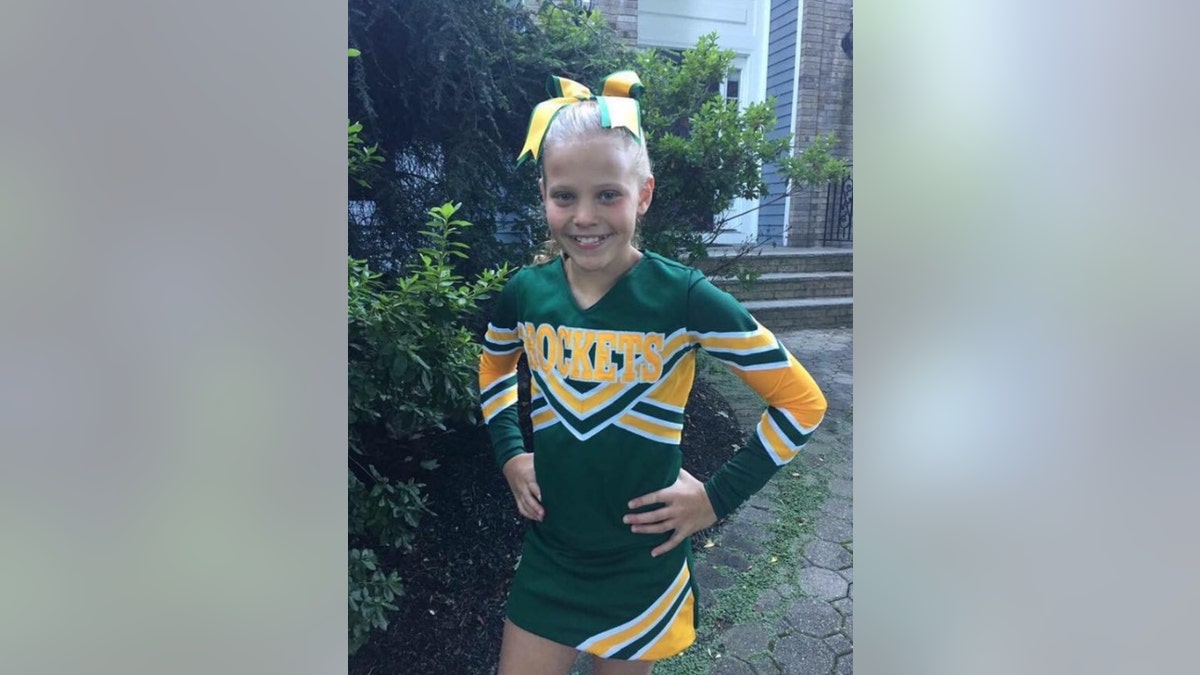 Mallory Grossman wearing a cheerleading uniform