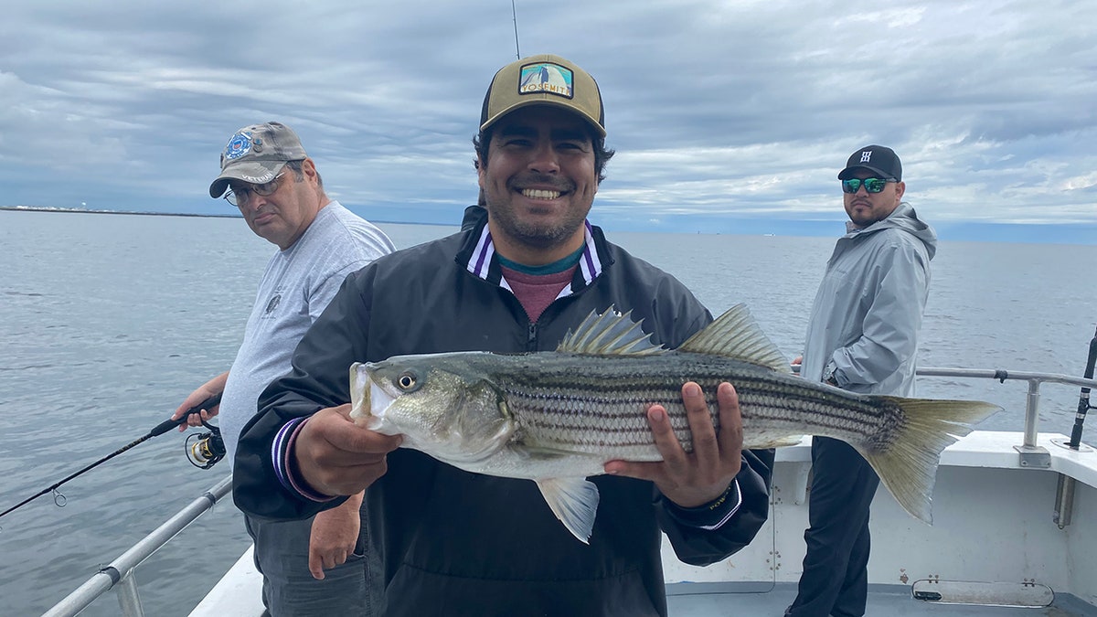 veteran holds up a fish