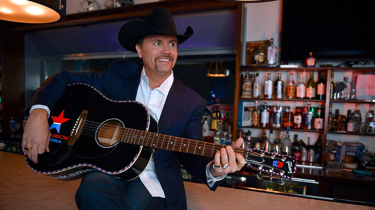 John Rich strums guitar at Redneck Riviera bar