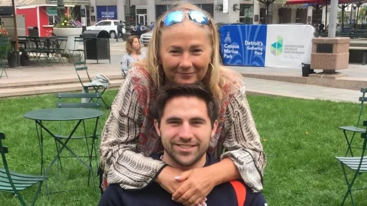 Doug Kantor, seated, with mother embracing him