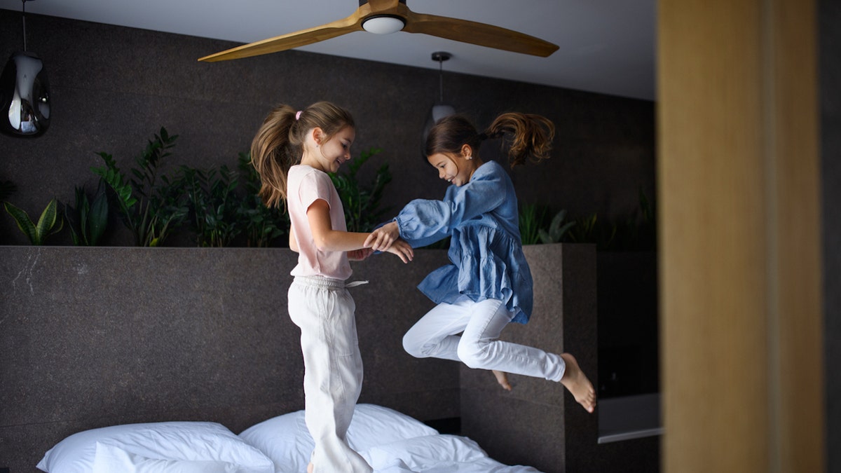 Kids jumping on bed