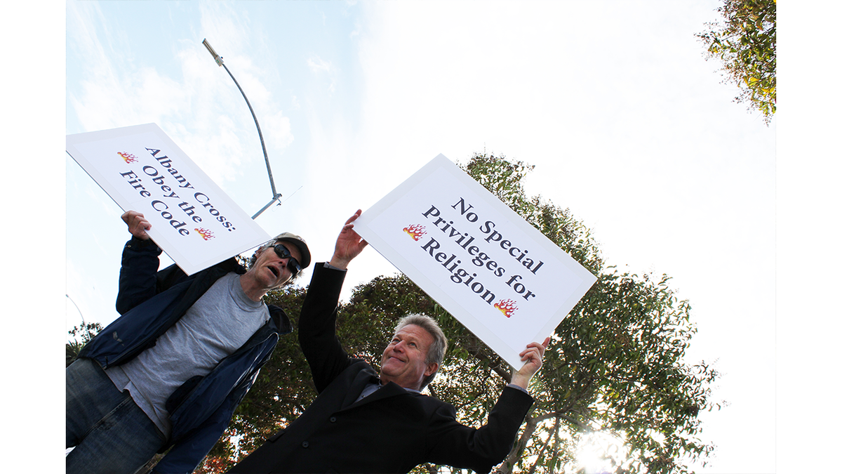 photo of atheists protesting cross