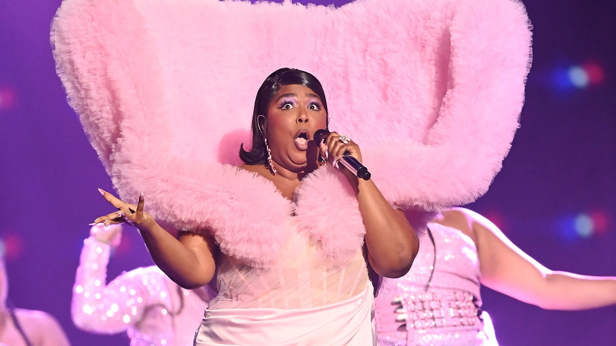 Lizzo in a pink outfit with a furry train that stands up at the Brit Awards