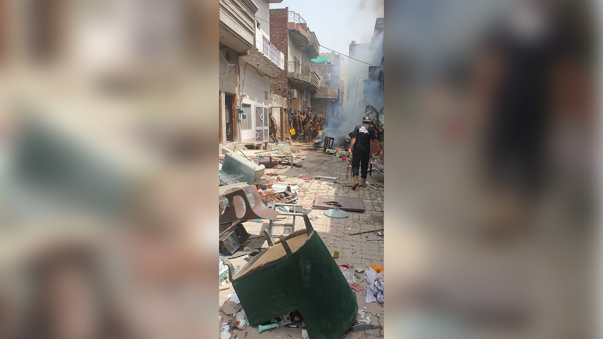 Furniture and other looted property items are tossed about the street in Pakistan