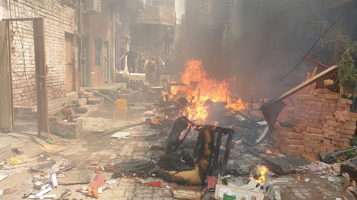 Chairs and other furniture and proprty is burned on the street in Pakistan