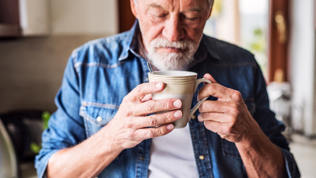 Man smelling coffee