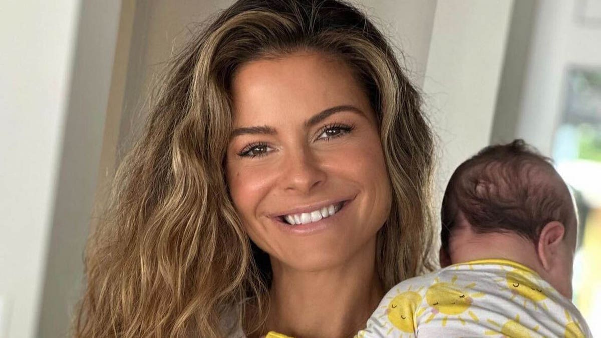 maria menounos smiling and holding her baby daughter