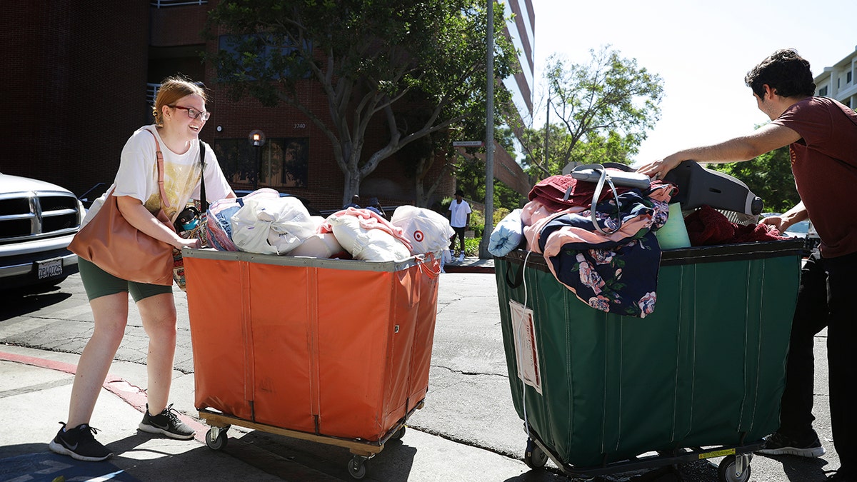 Students pushing carts on college move-in day