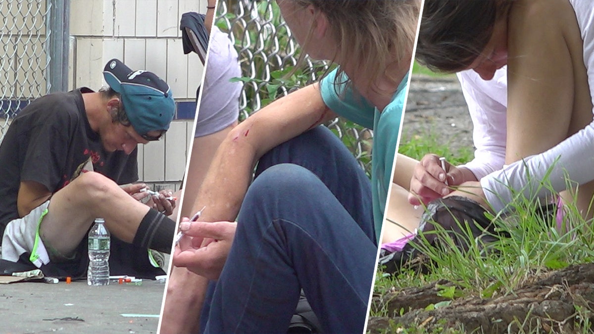 Drug users sitting down injecting themselves with needles