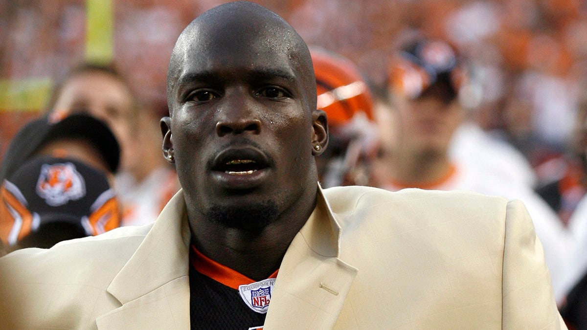 Chad Johnson on sideline with gold jacket