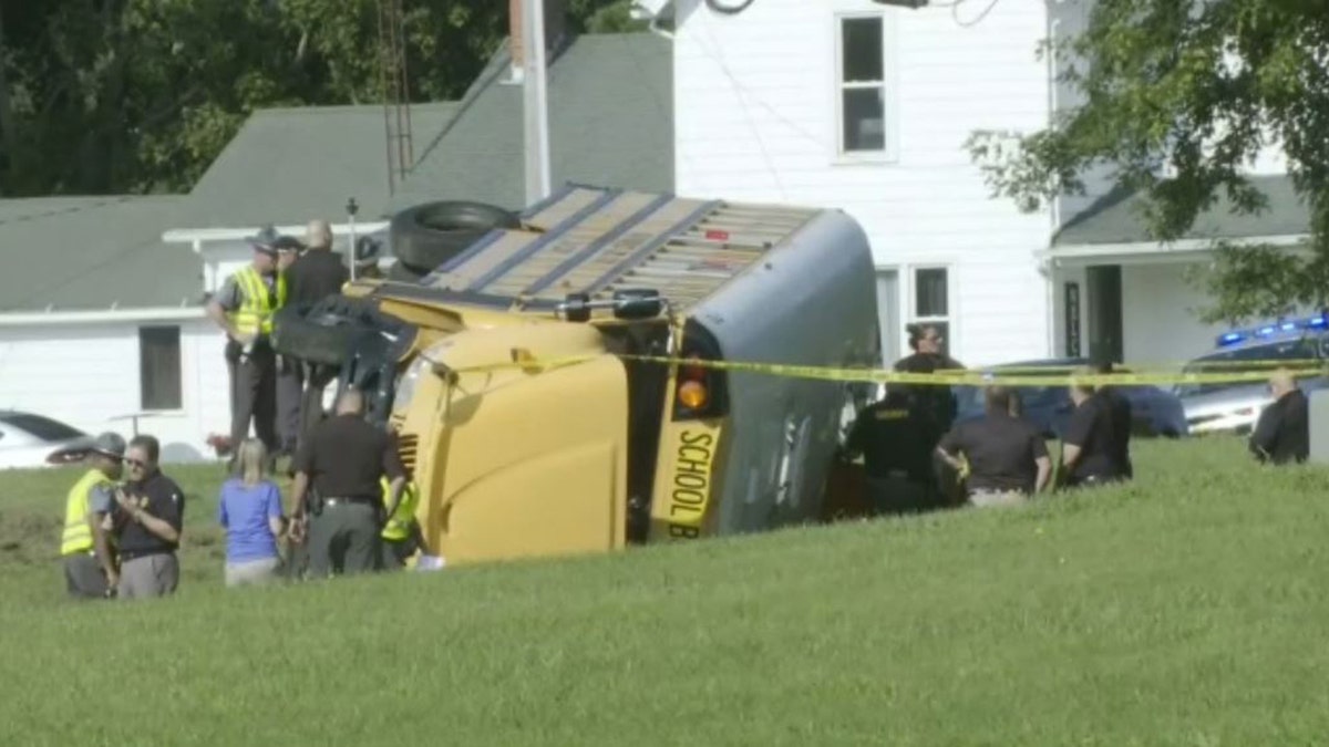 investigators outside overturned school bus