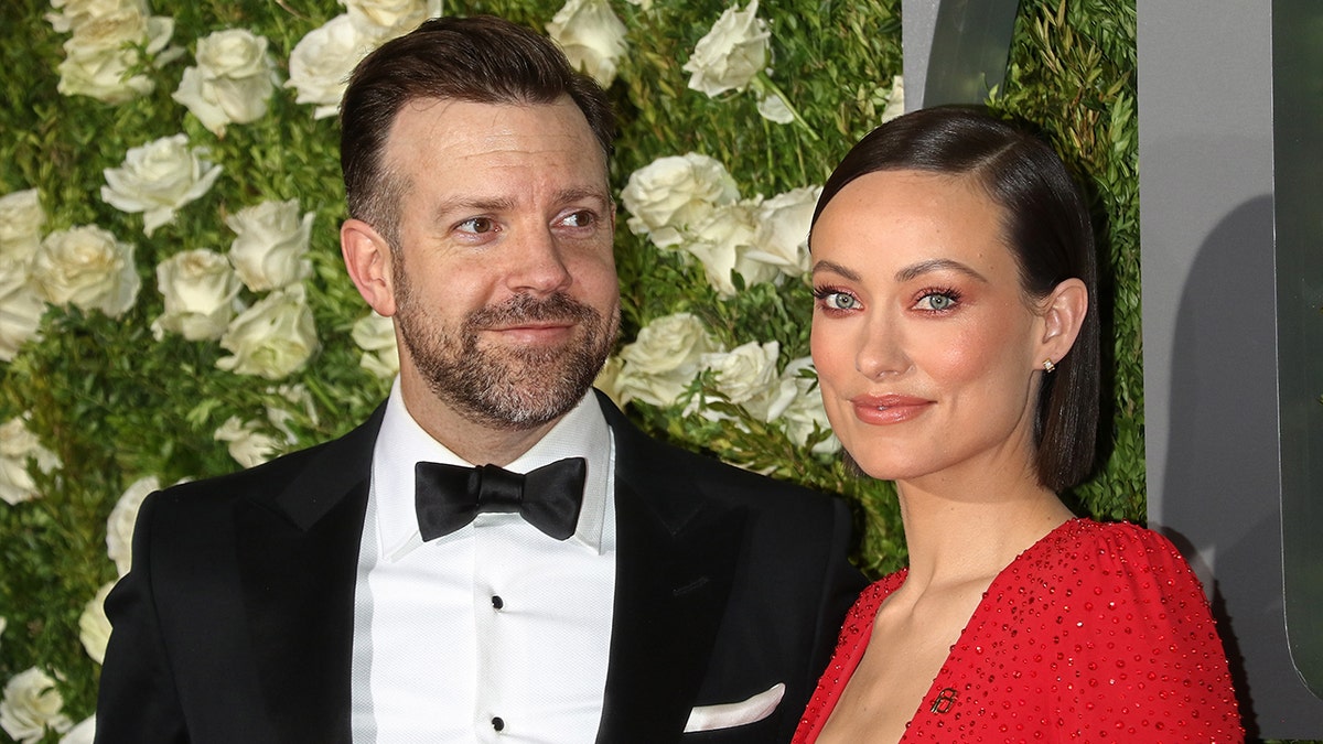 Olivia Wilde wears red dress at red carpet event with Jason Sudeikis