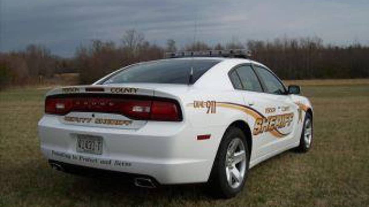 white sheriff's patrol car in field
