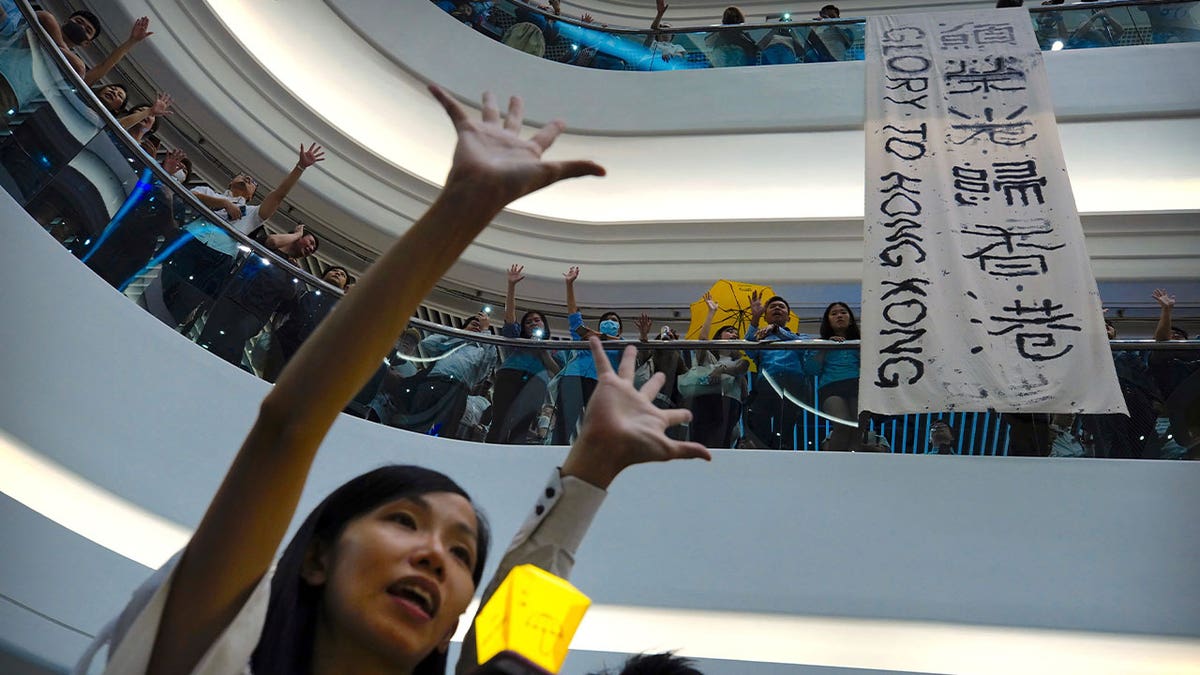 Demonstrators sing a theme song written by protestors, "Glory to Hong Kong," in Hong Kong on Sept. 12, 2019. 