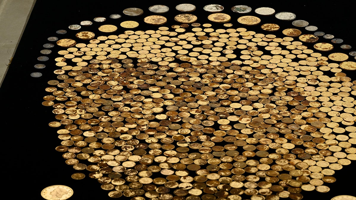 raw coins on black table