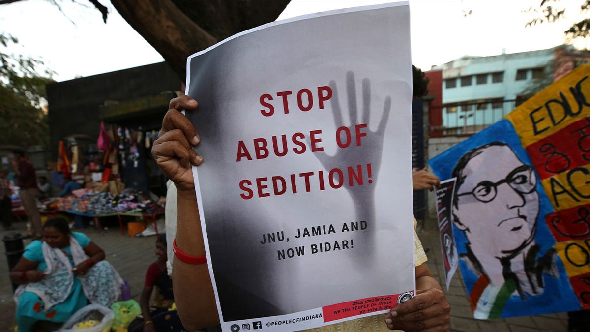 protestor holding placard against abuse of sedition
