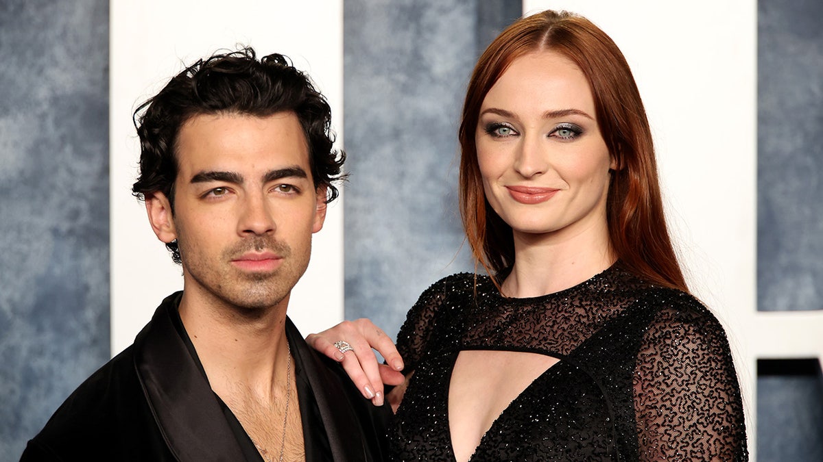 Joe Jonas in black and Sophie Turner in a sparkly lace black dress on the carpet at the Vanity Fair Oscar party