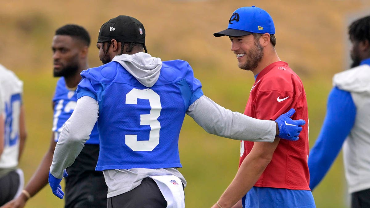 Matthew Stafford talks with Cam Akers during practice