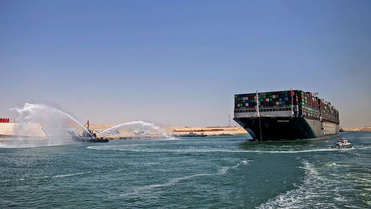 Tugboat next to tanker in Suez Canal