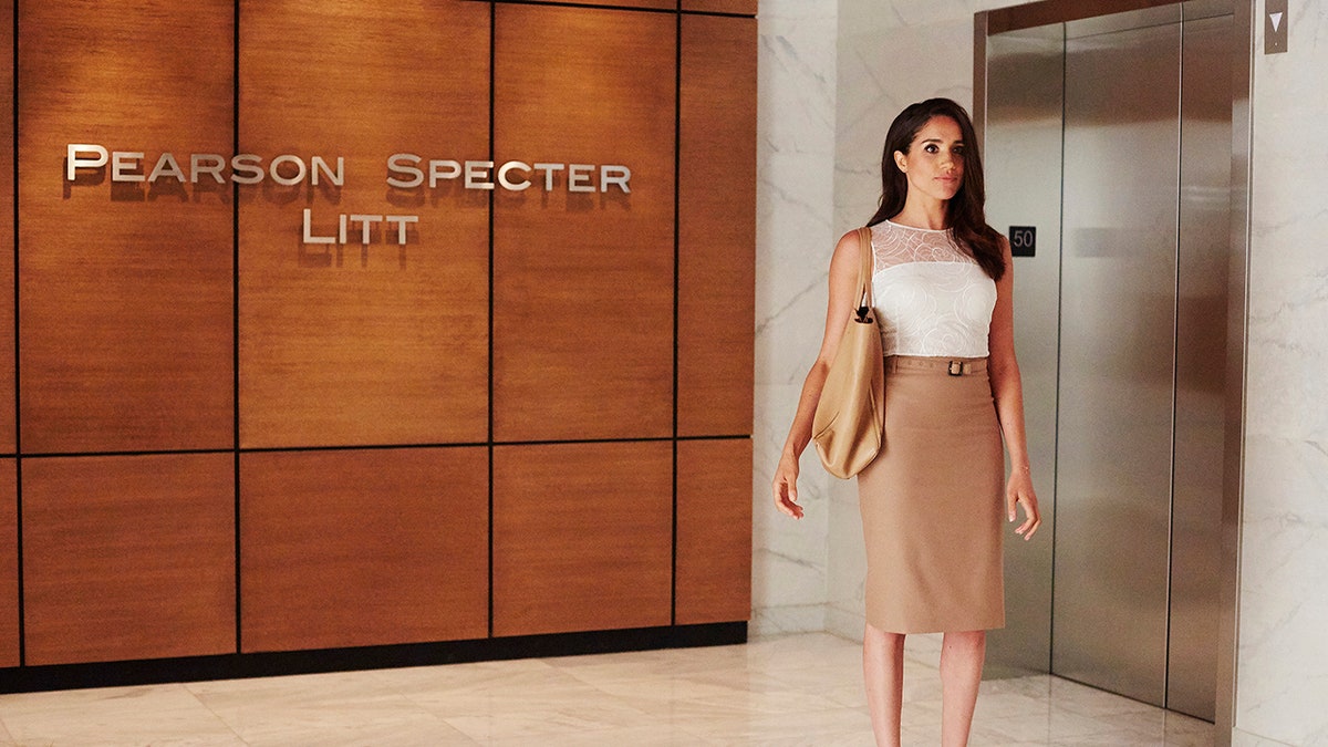 Meghan Markle in a long tan skirt and white blouse as Rachel in "Suits"