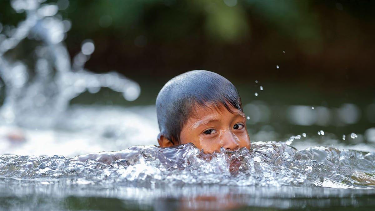 Indigenous Wari' boy swims 