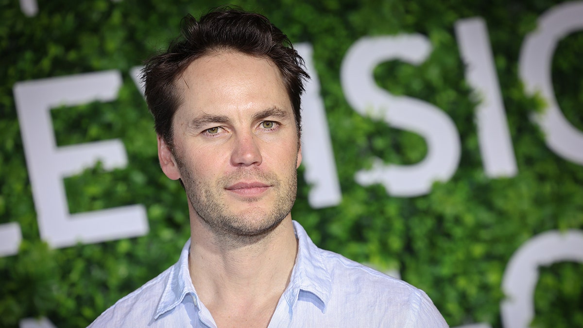 Taylor Kitsch in a light blue button down shirt in Monte-Carlo