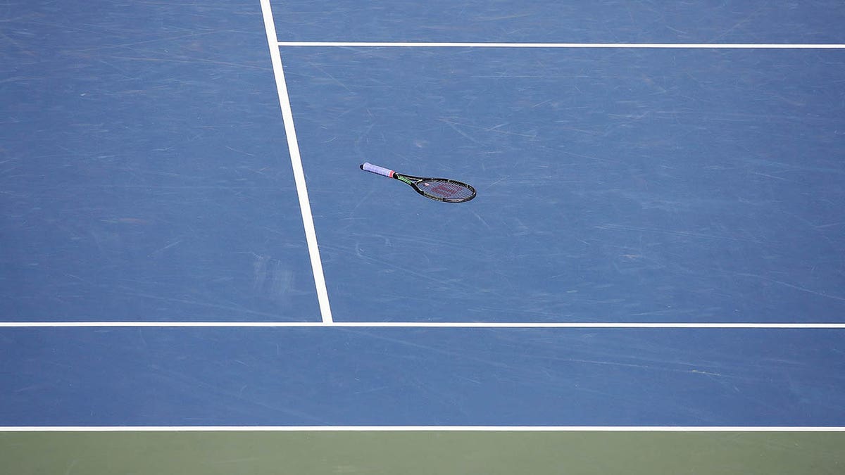tennis racket on a hard court