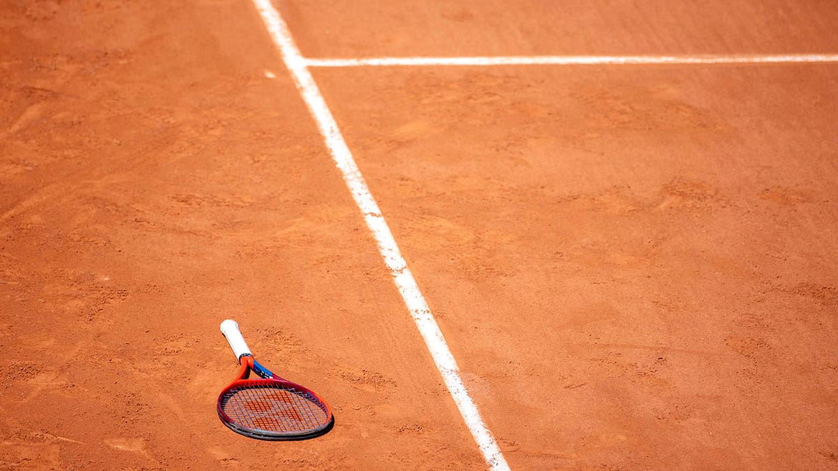 tennis racket on a clay court