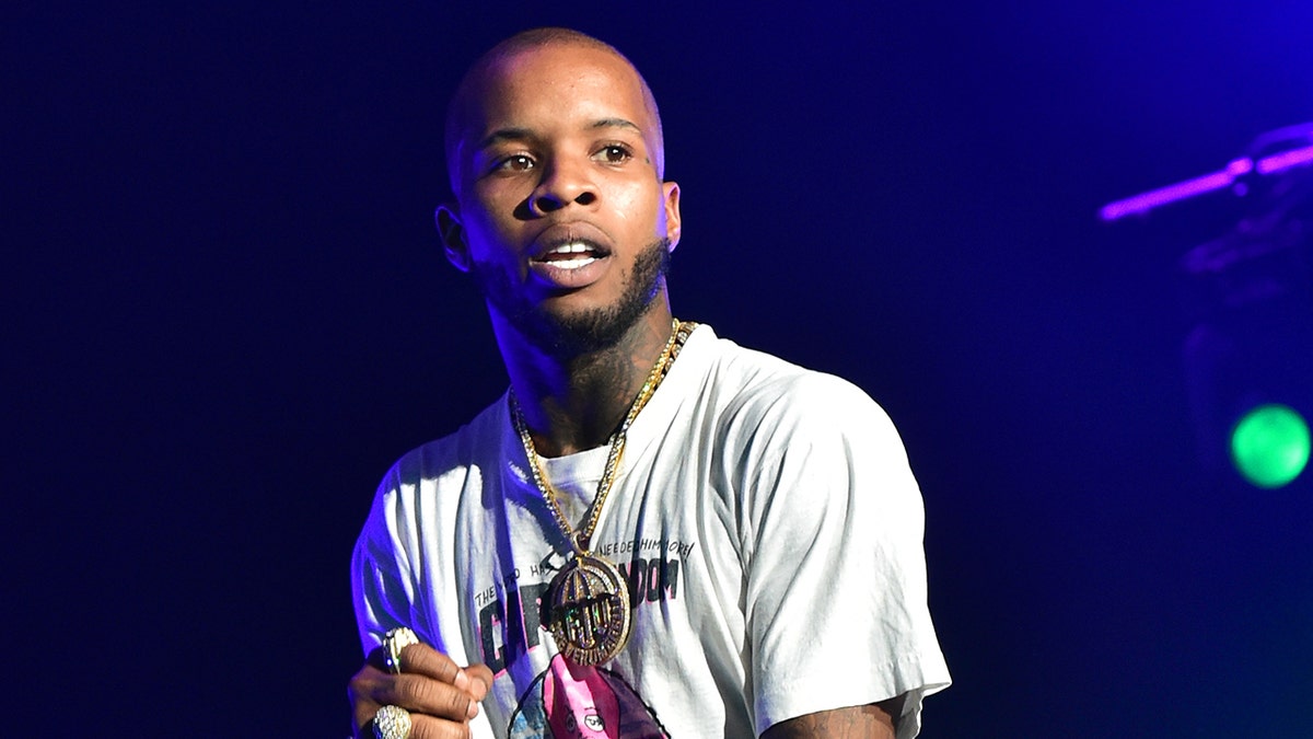 Rapper Tory Lanez wears gold chain necklace while performing on stage