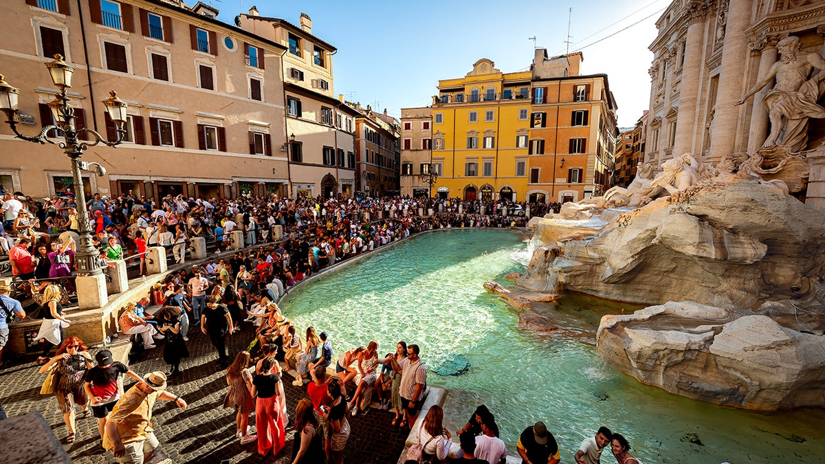 Tourists gathered around the Trevi Fountain