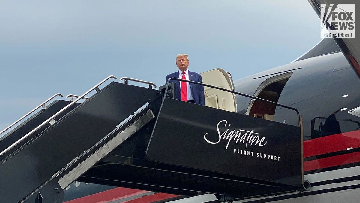 Donald Trump wears suit and red tie